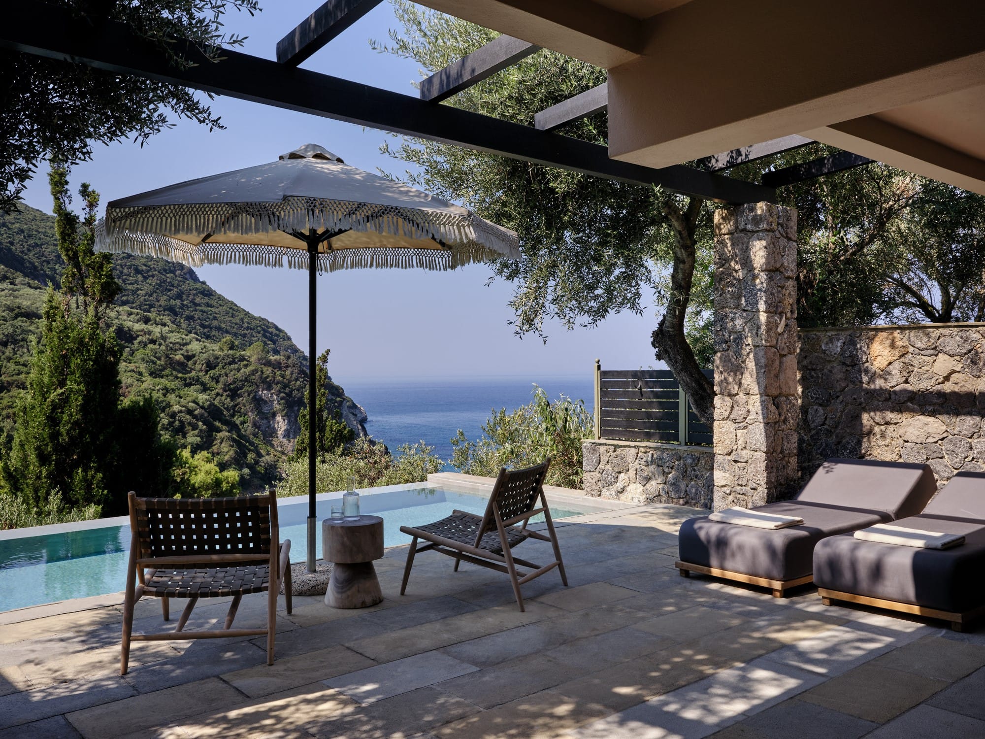 a patio with chairs and umbrella
