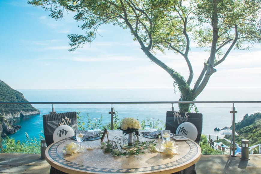 a table with a tree and a body of water in the background