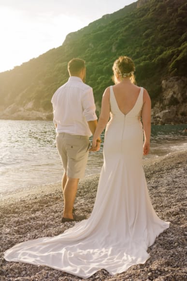 a man and woman walking on a beach