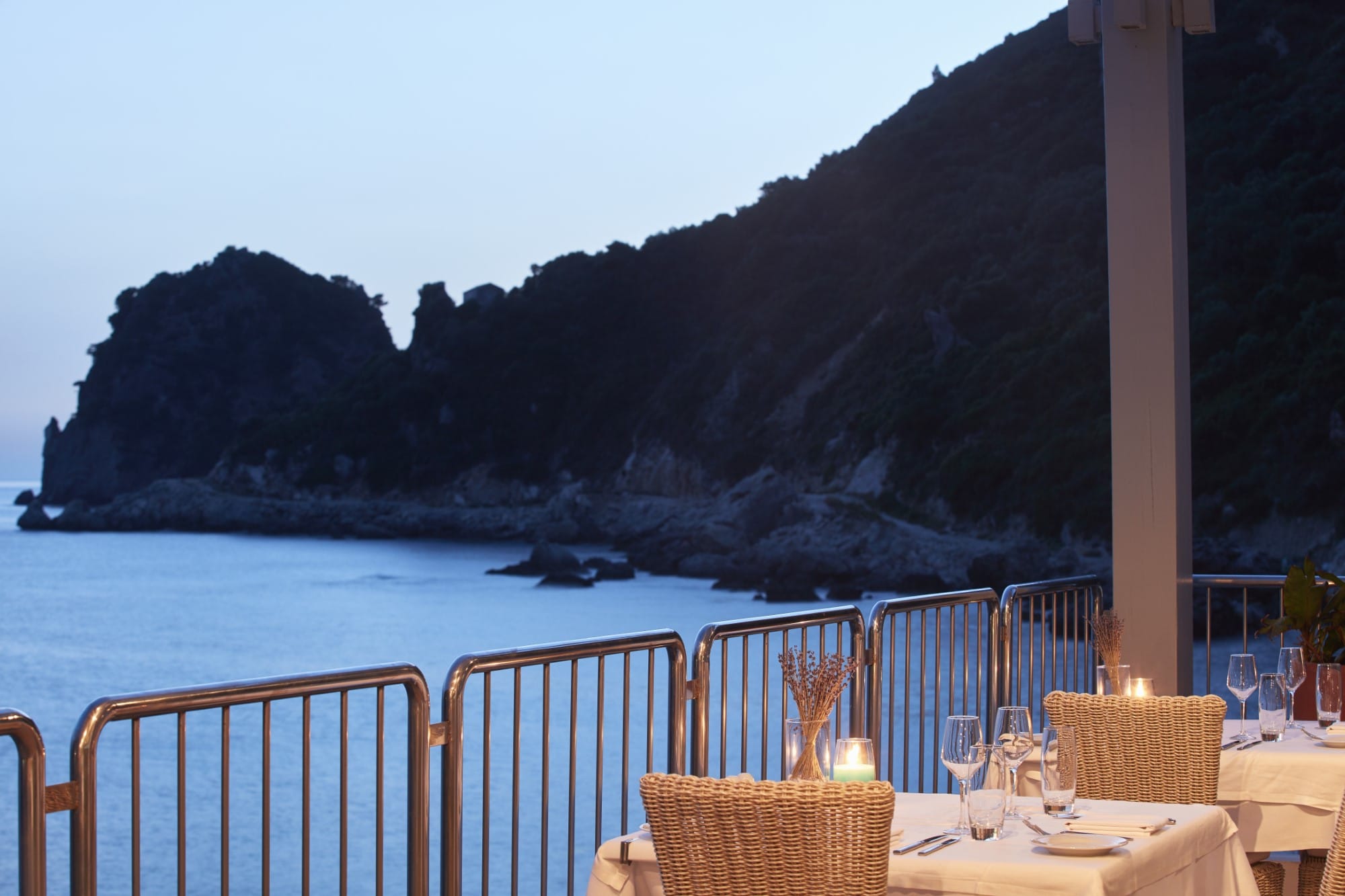 a table and chairs on a deck overlooking a body of water