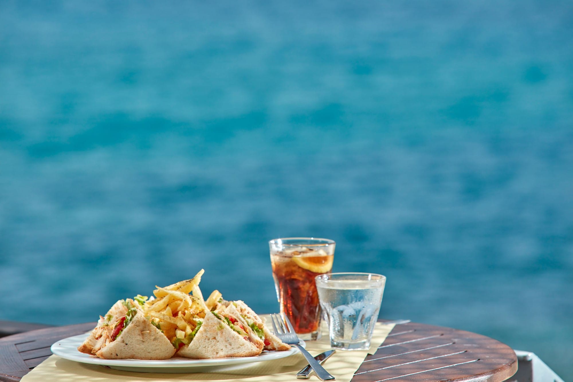 a plate of food and a glass of beer on a table