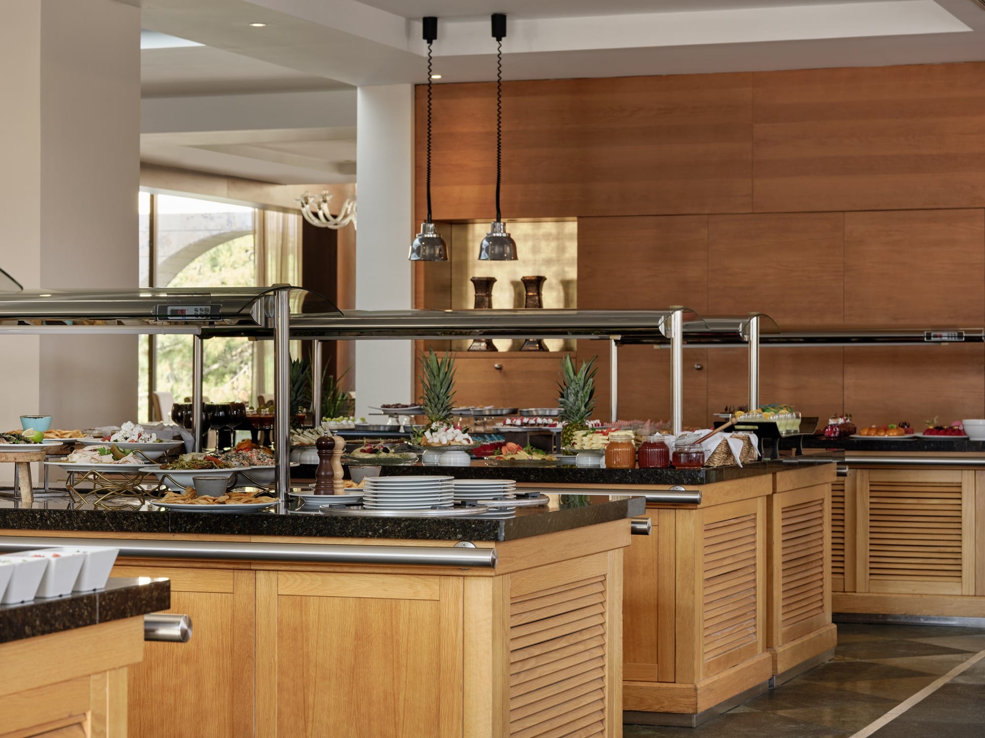 a kitchen with a bar and a large window