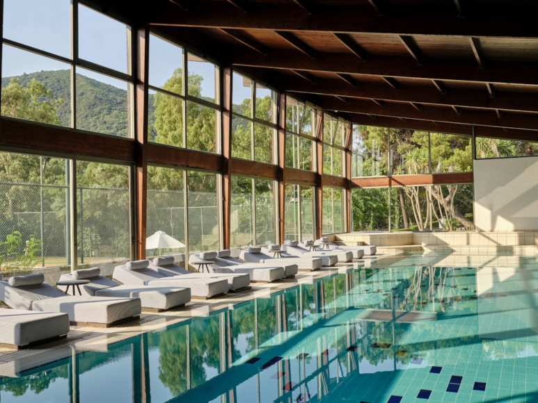 a swimming pool with chairs around it