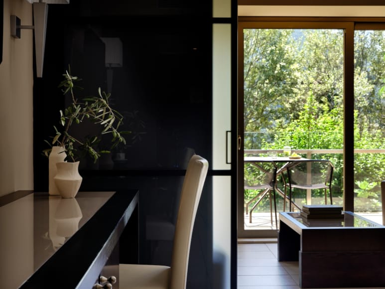 a bathroom with a chair and a plant in it