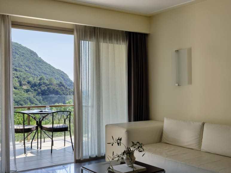 a living room with a view of mountains and a lake