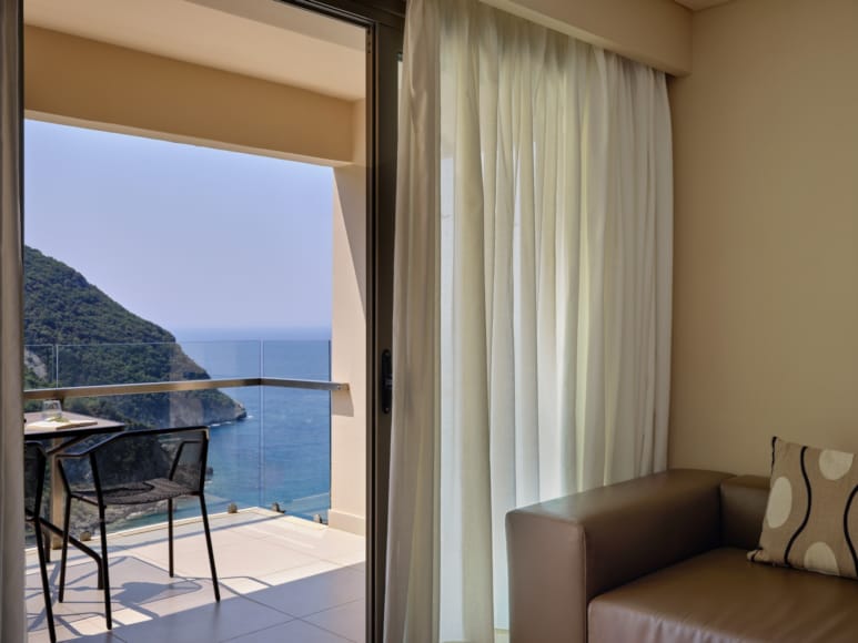 a room with a view of the ocean and a couch