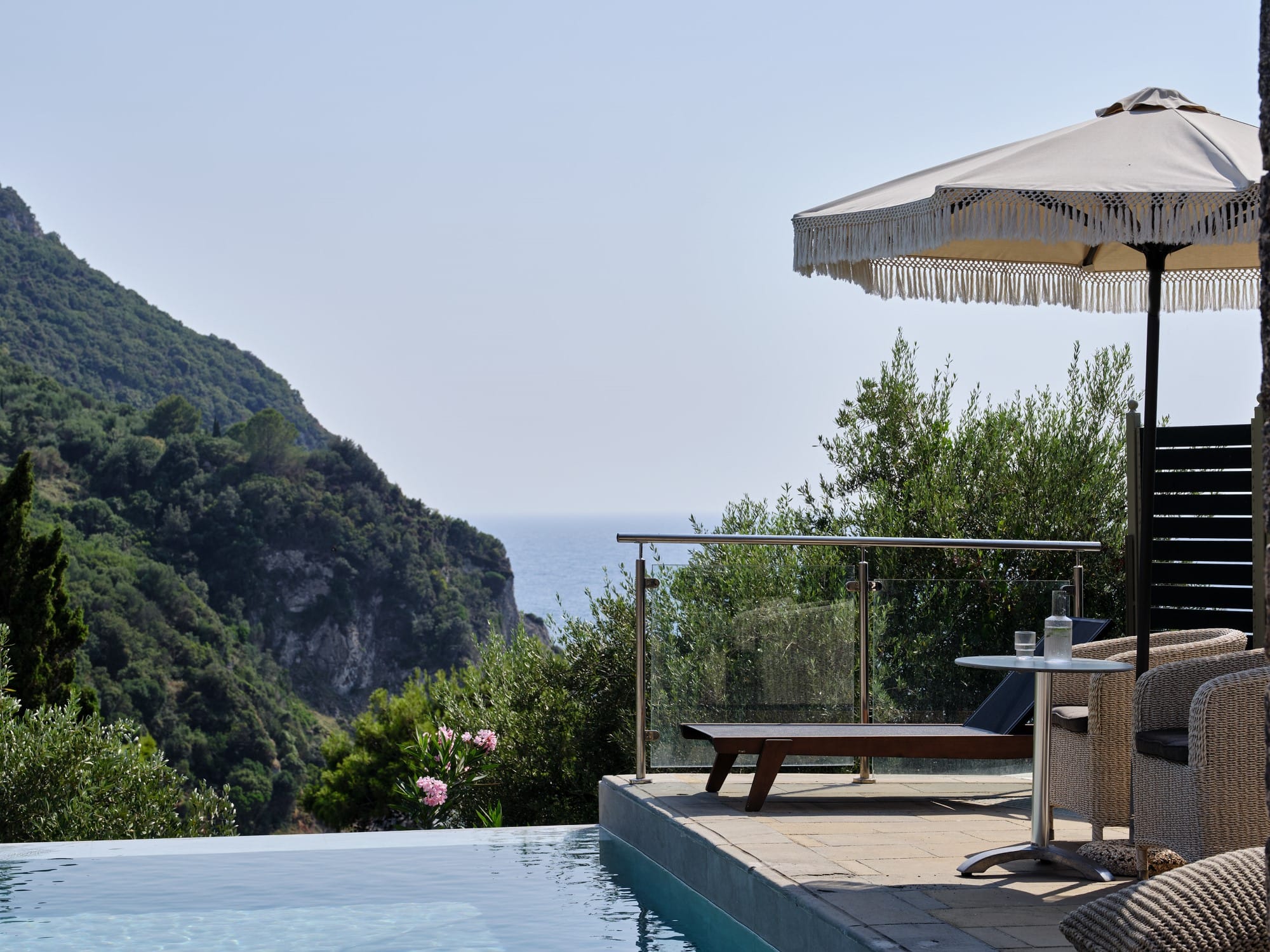 a pool with a deck and umbrella