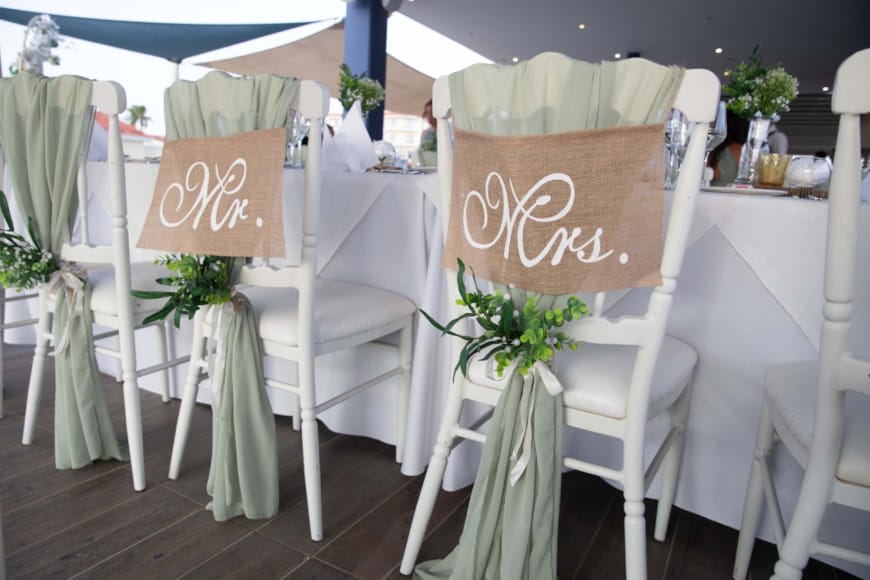 a room with white chairs and a sign