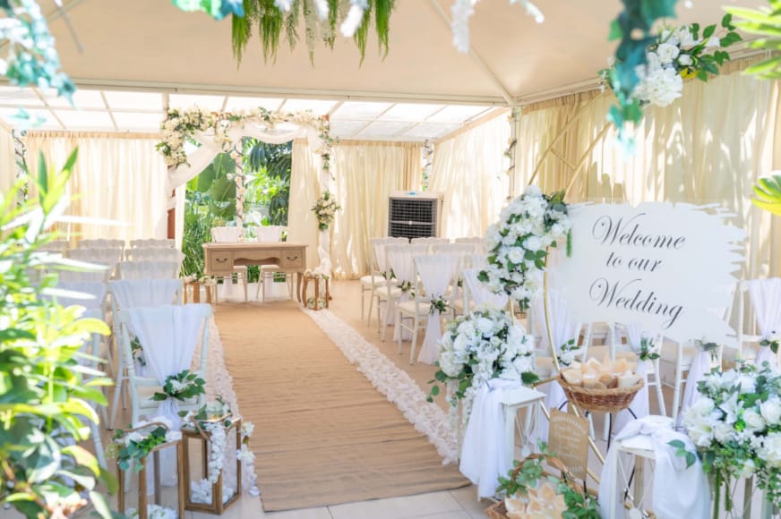 a room with white tables and white cloths and white flowers