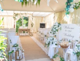 a room with white tables and white cloths and white flowers