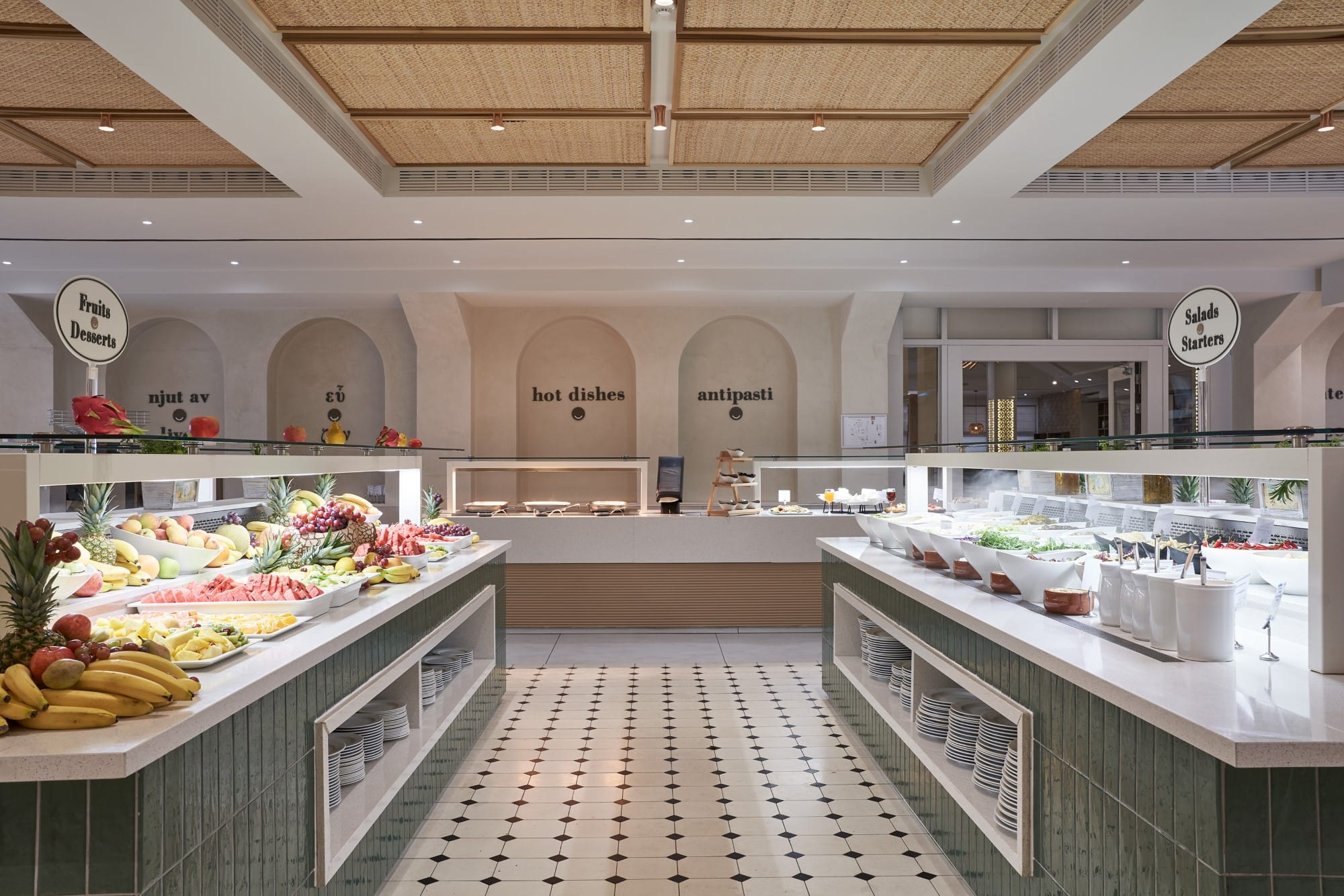 a large kitchen with a counter and fruit on the counter