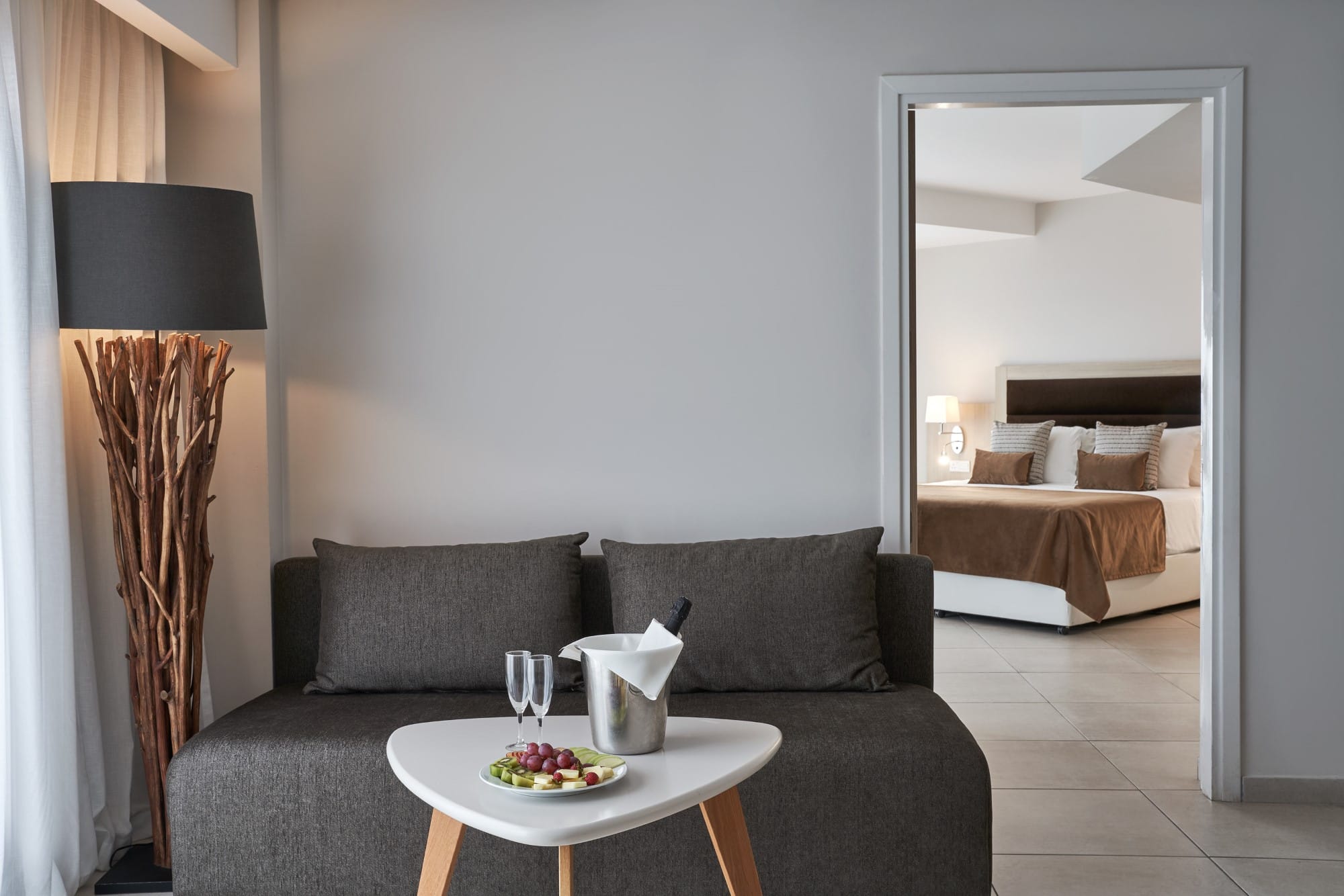 a living room with a bed and a mirror