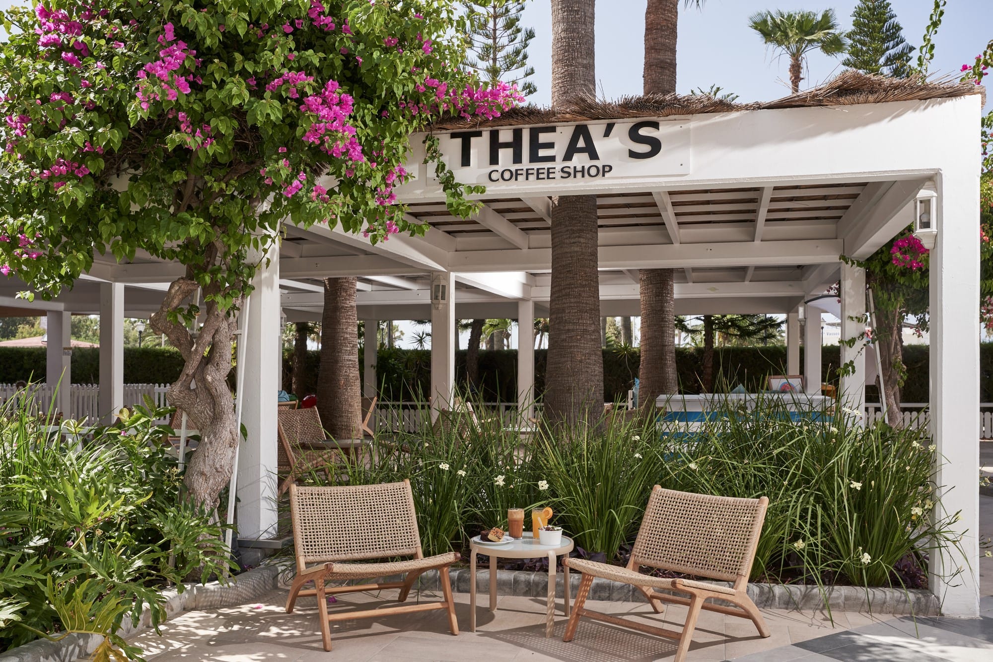 a patio with chairs and a table