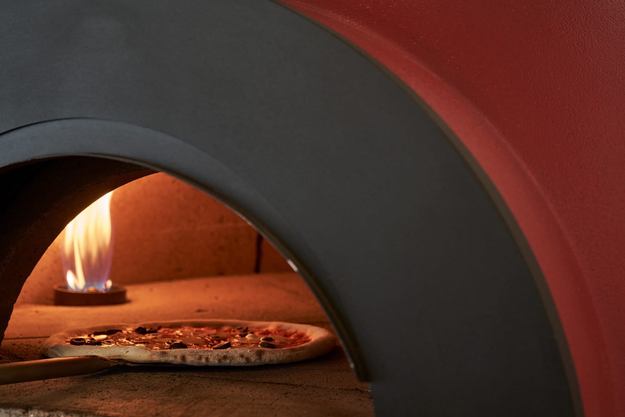 a pizza in a pizza oven