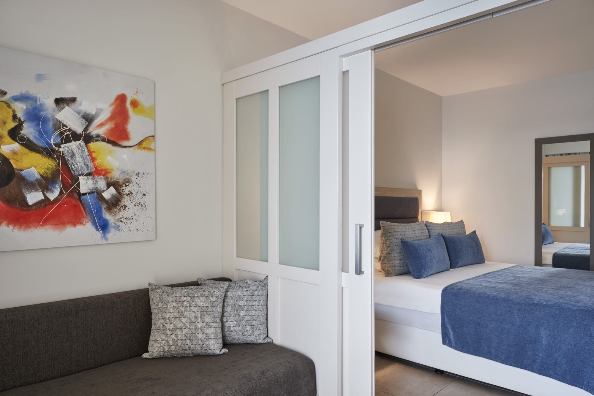 a bedroom with a bed and a couch