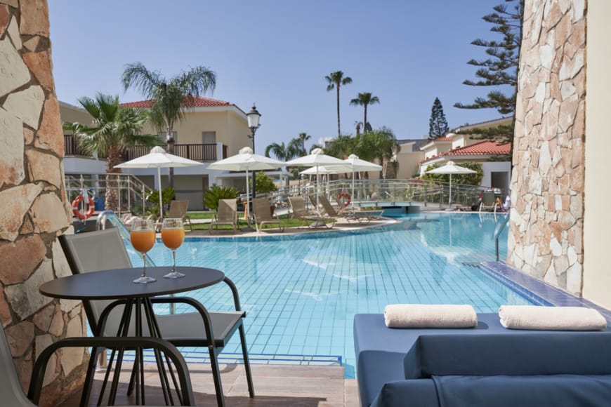 a pool with chairs and umbrellas