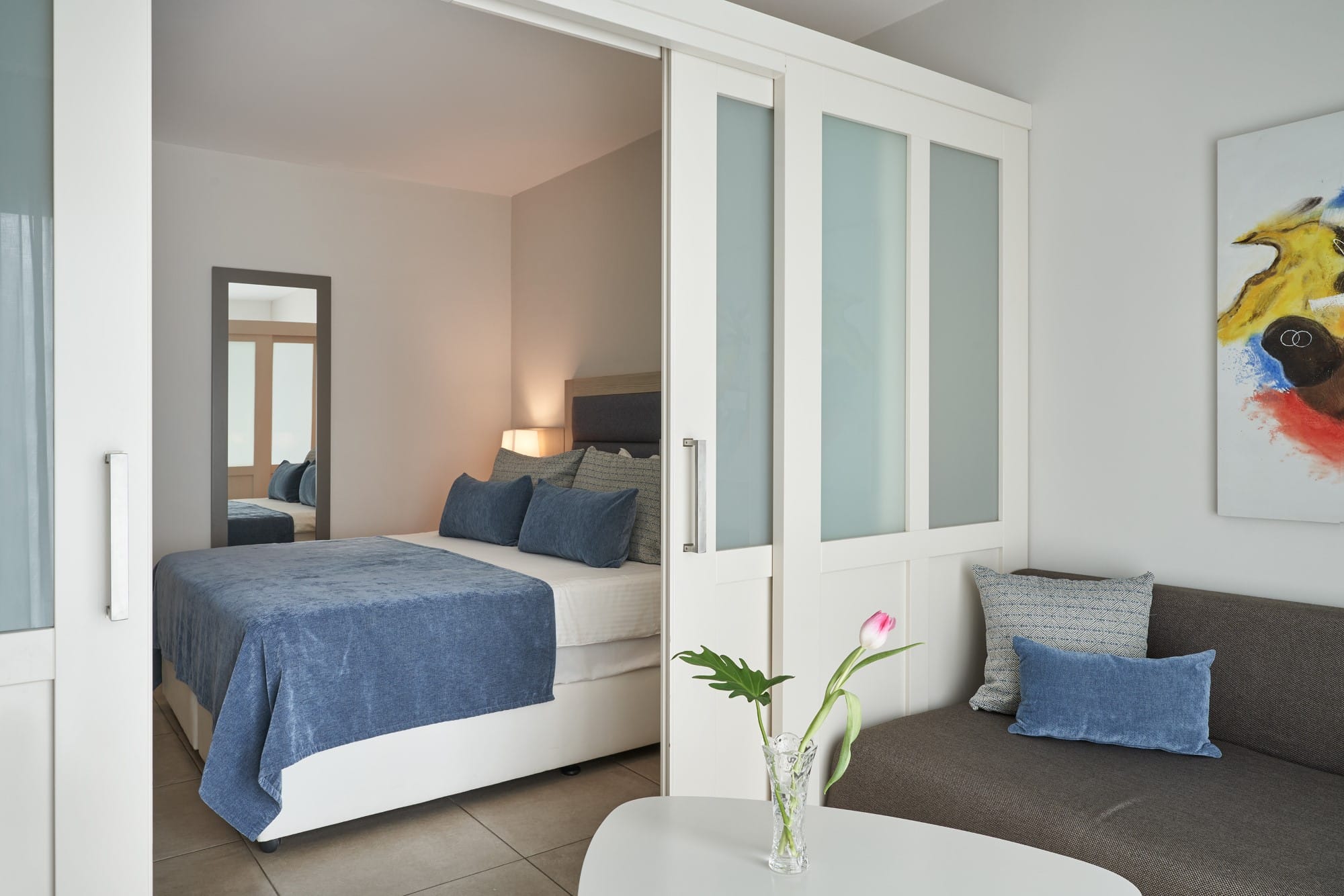 a bedroom with a bed and a couch