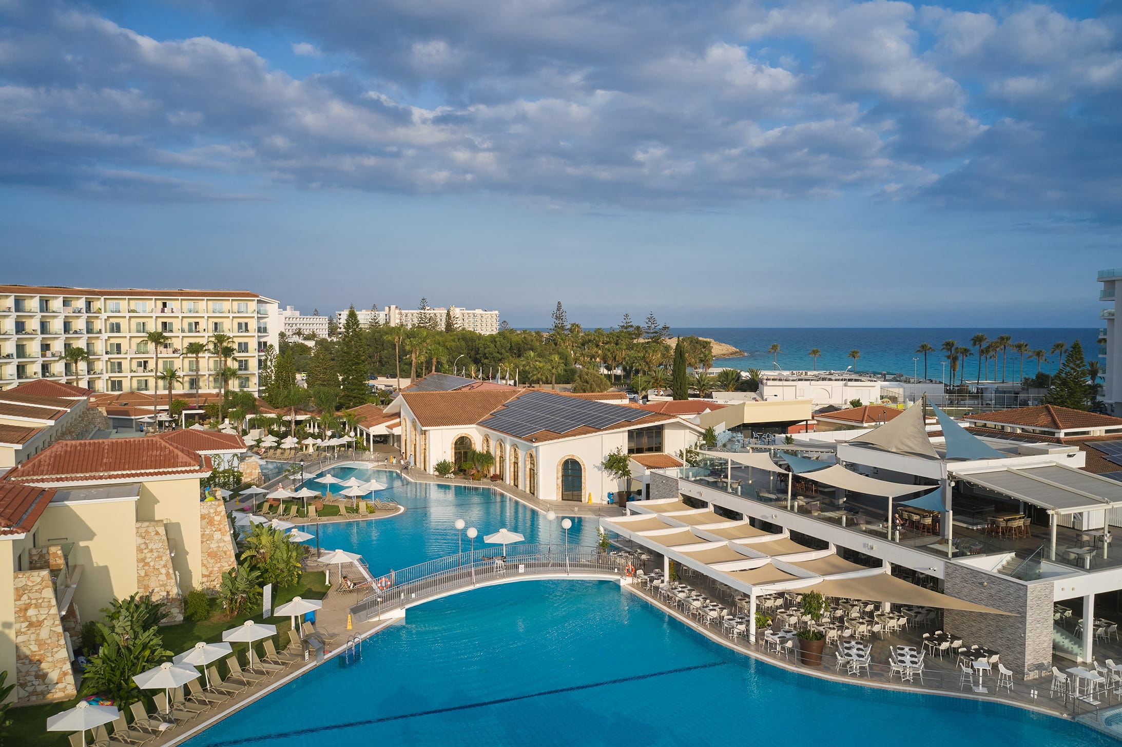 a pool and buildings by the water