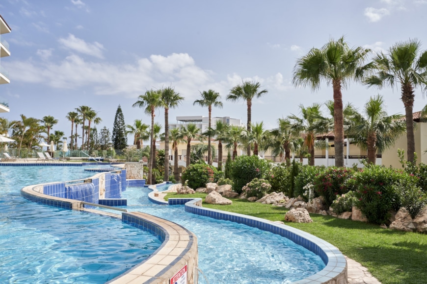 a pool with trees around it