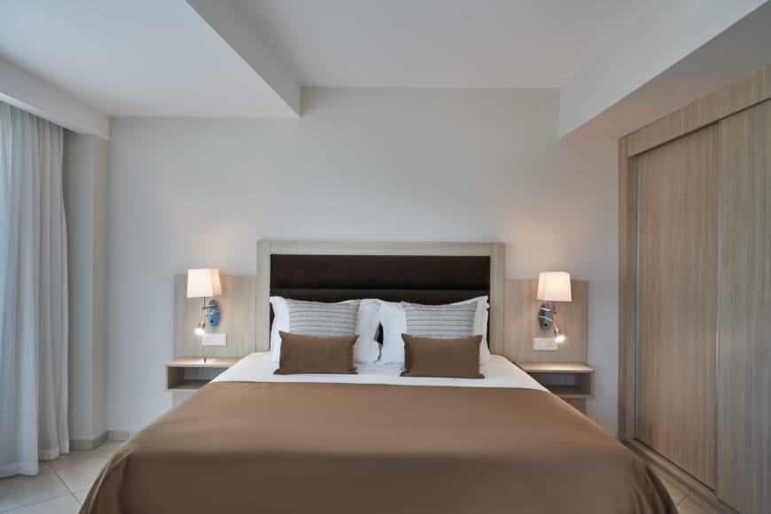 a bed with lamps on either side