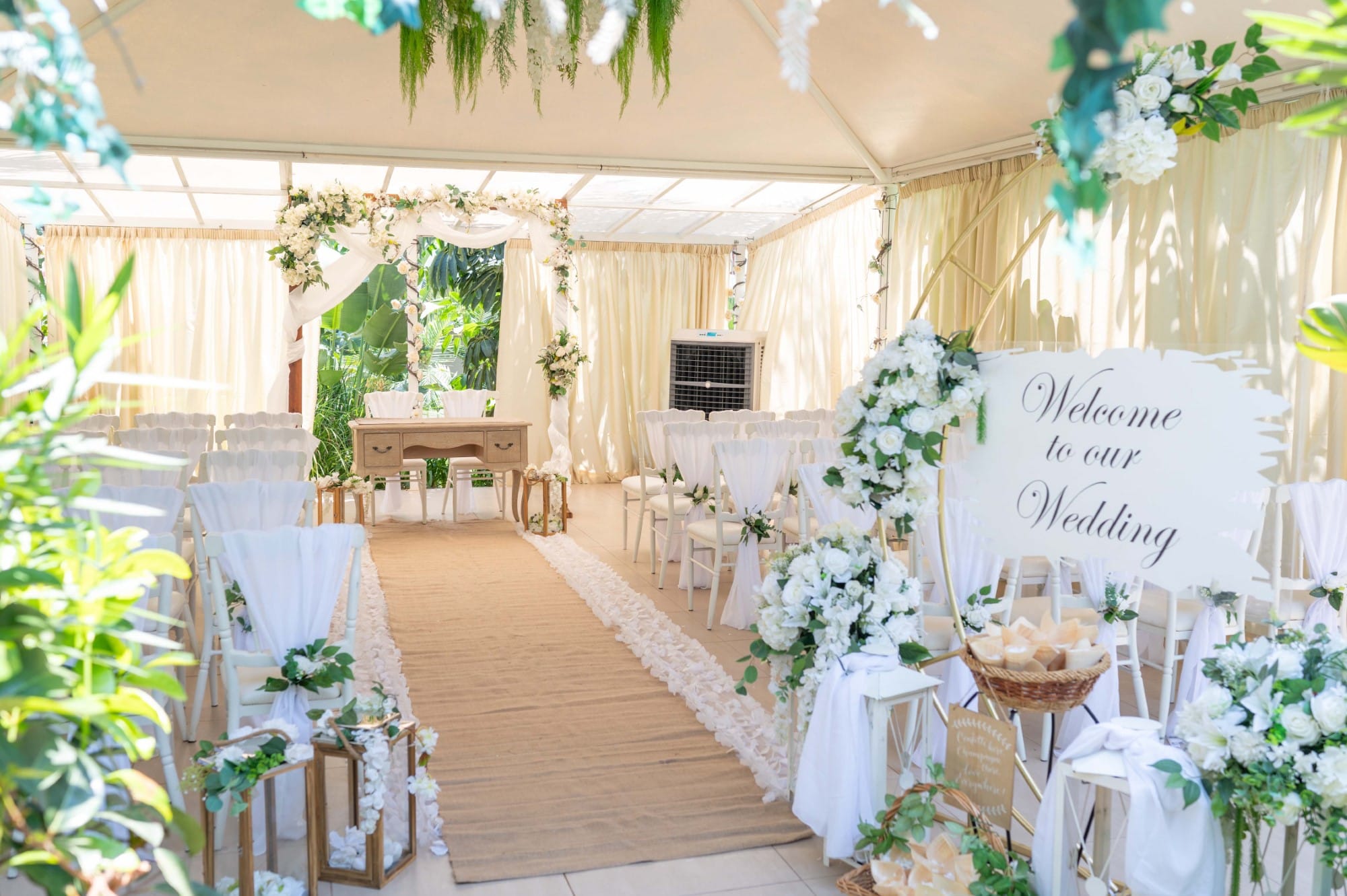 a room with white tables and white cloths and white flowers