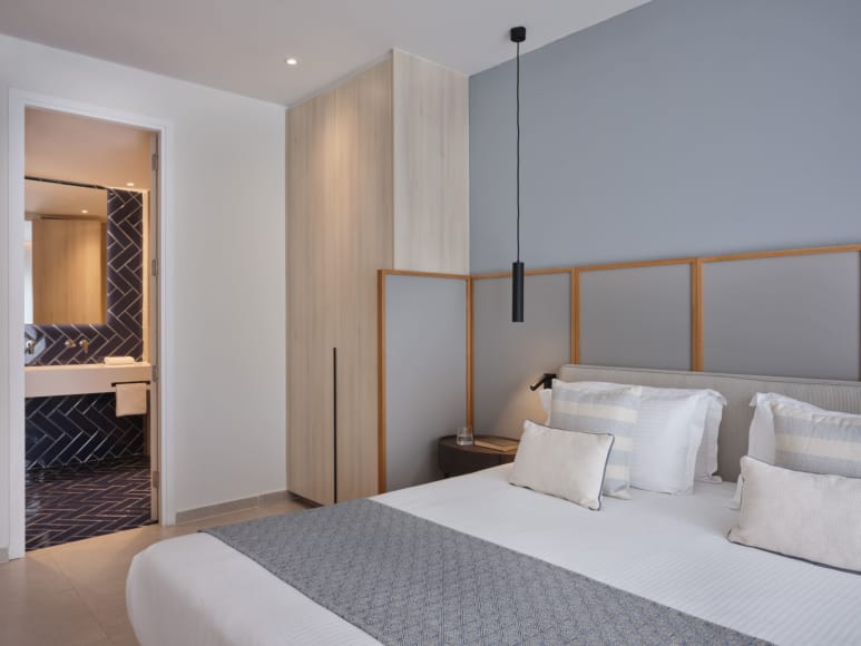 a bedroom with a bed and a mirror