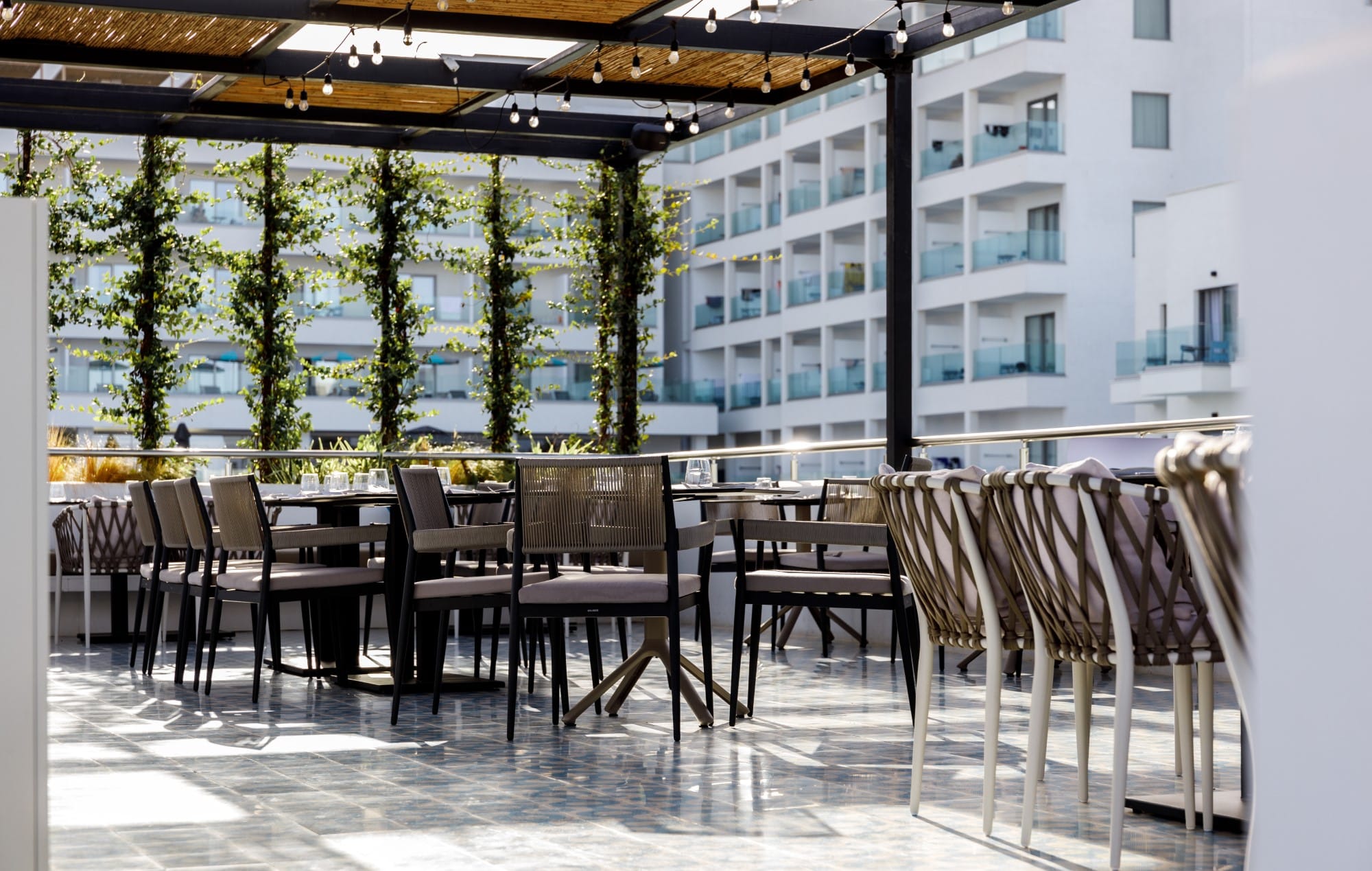 a patio with chairs and tables