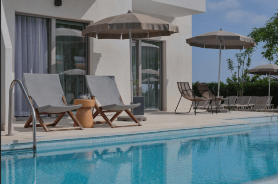 a pool with chairs and umbrellas