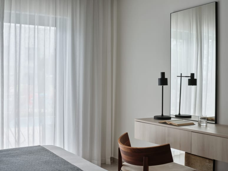 a room with a desk and a mirror