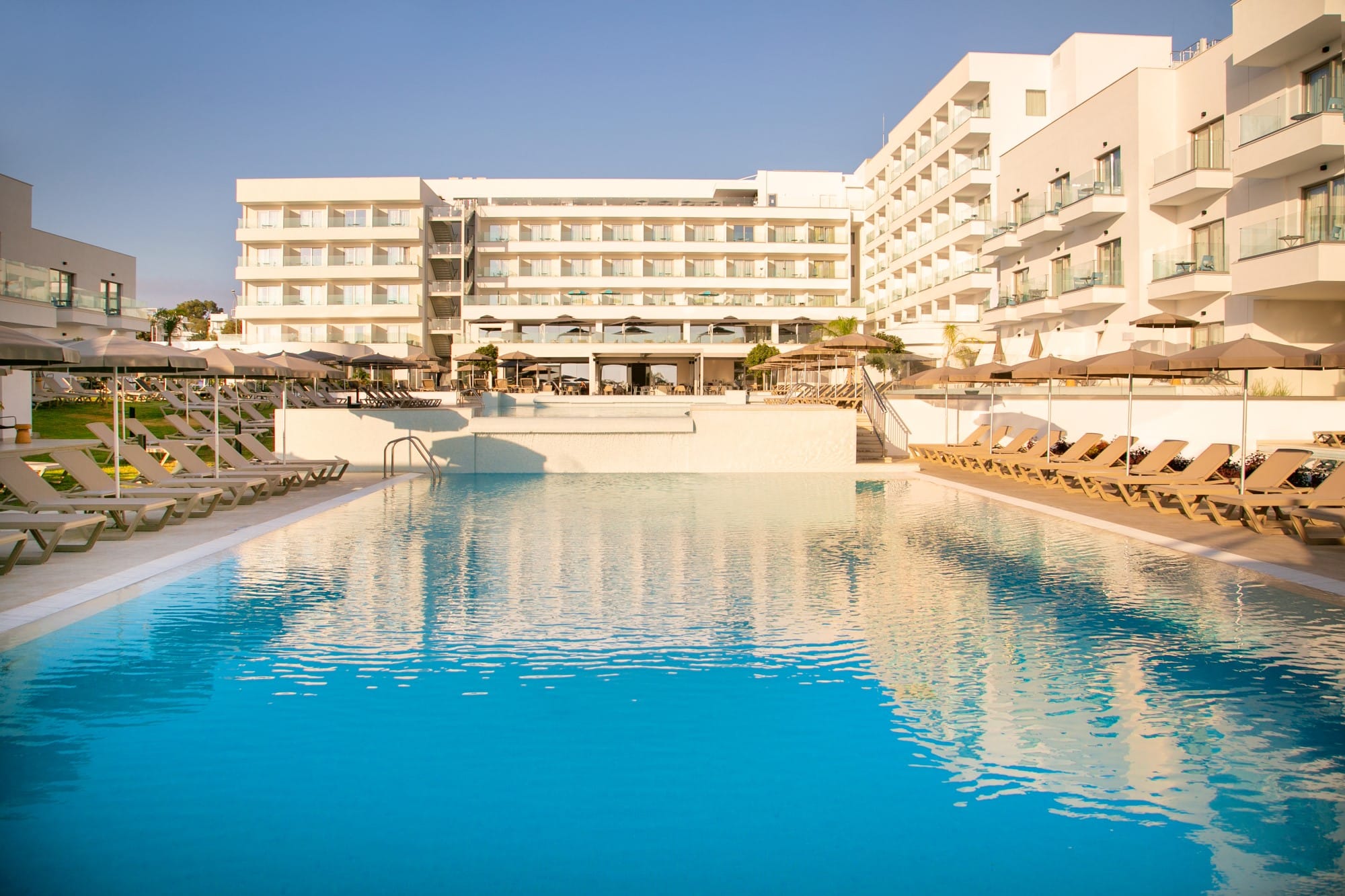 a pool with buildings in the background