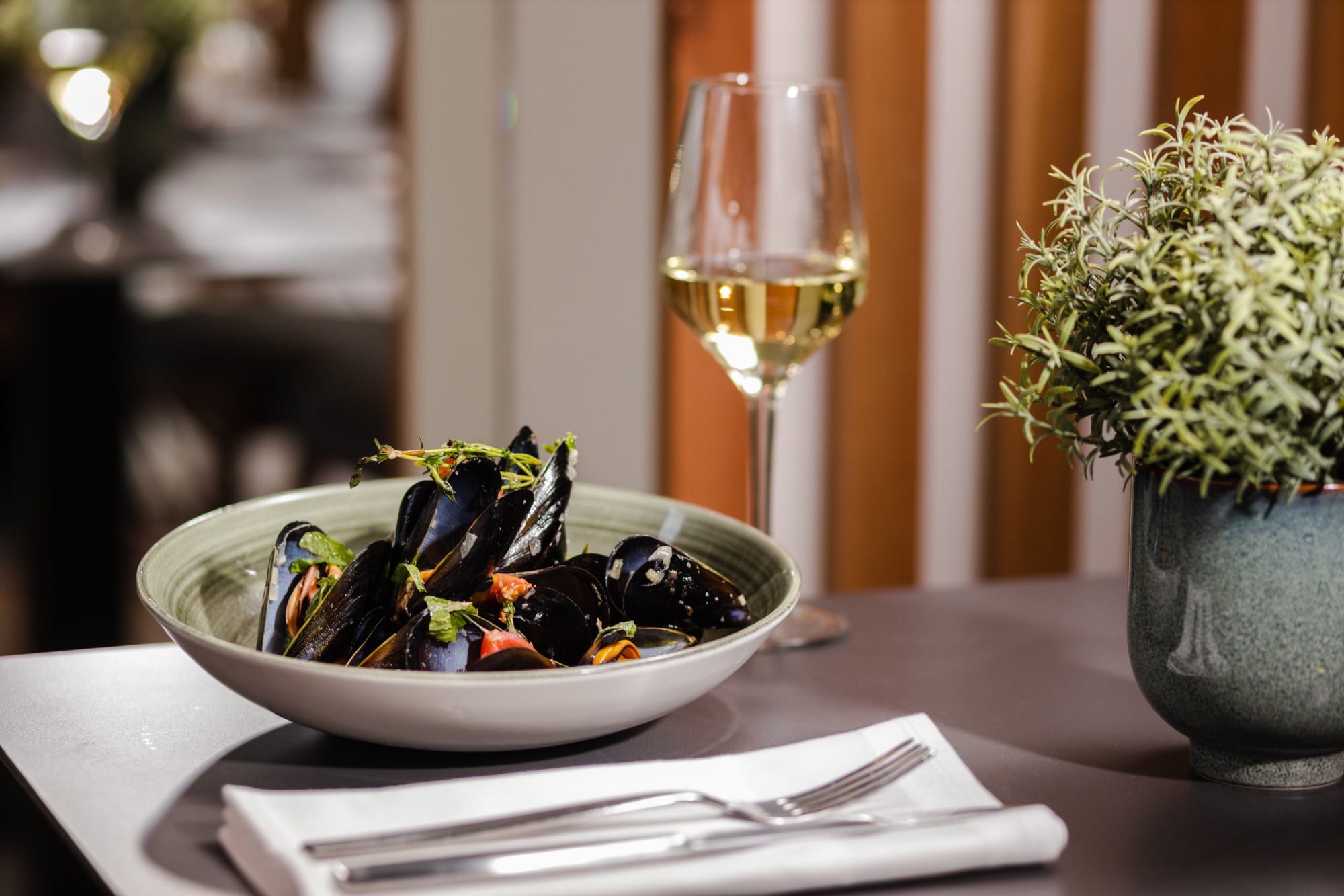 a bowl of fruit and a glass of wine