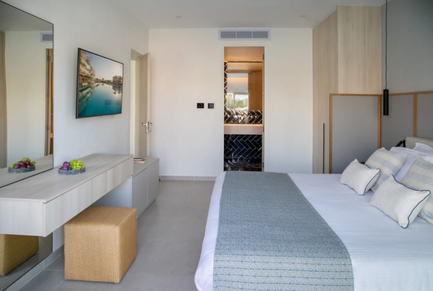 a room with a bed and a bench