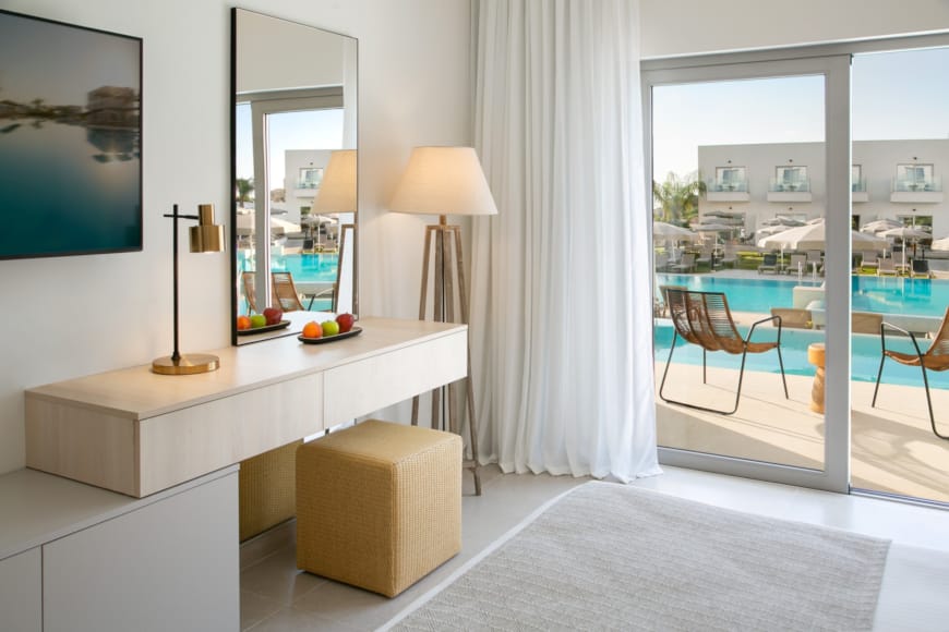 a room with a white table and a white wall with a window