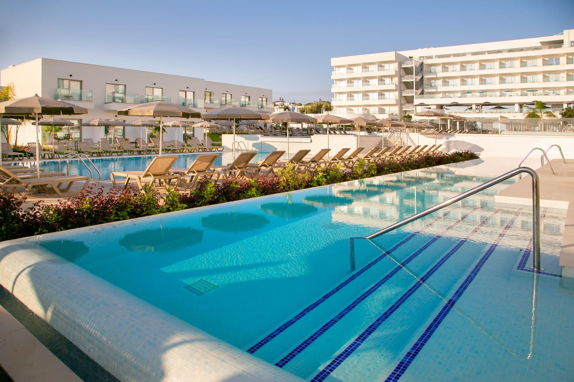 a swimming pool with chairs around it