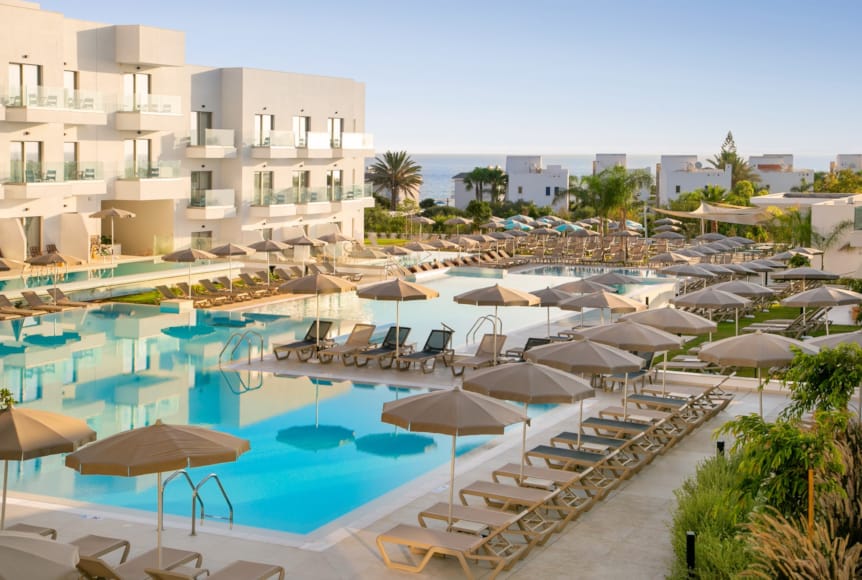 a pool with umbrellas and chairs