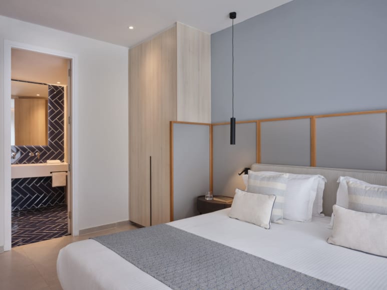 a bedroom with a bed and a mirror