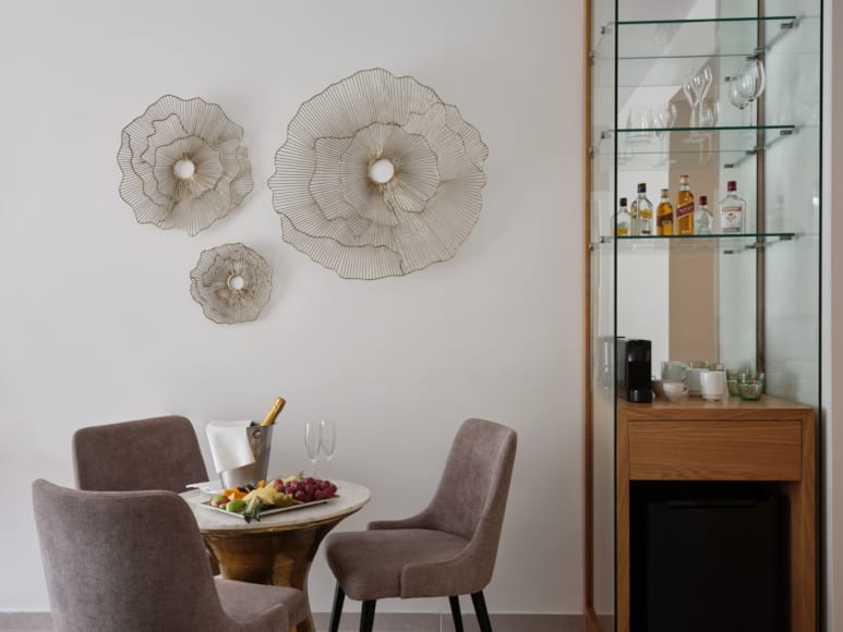 a table with a plate of food and a shelf with objects on it
