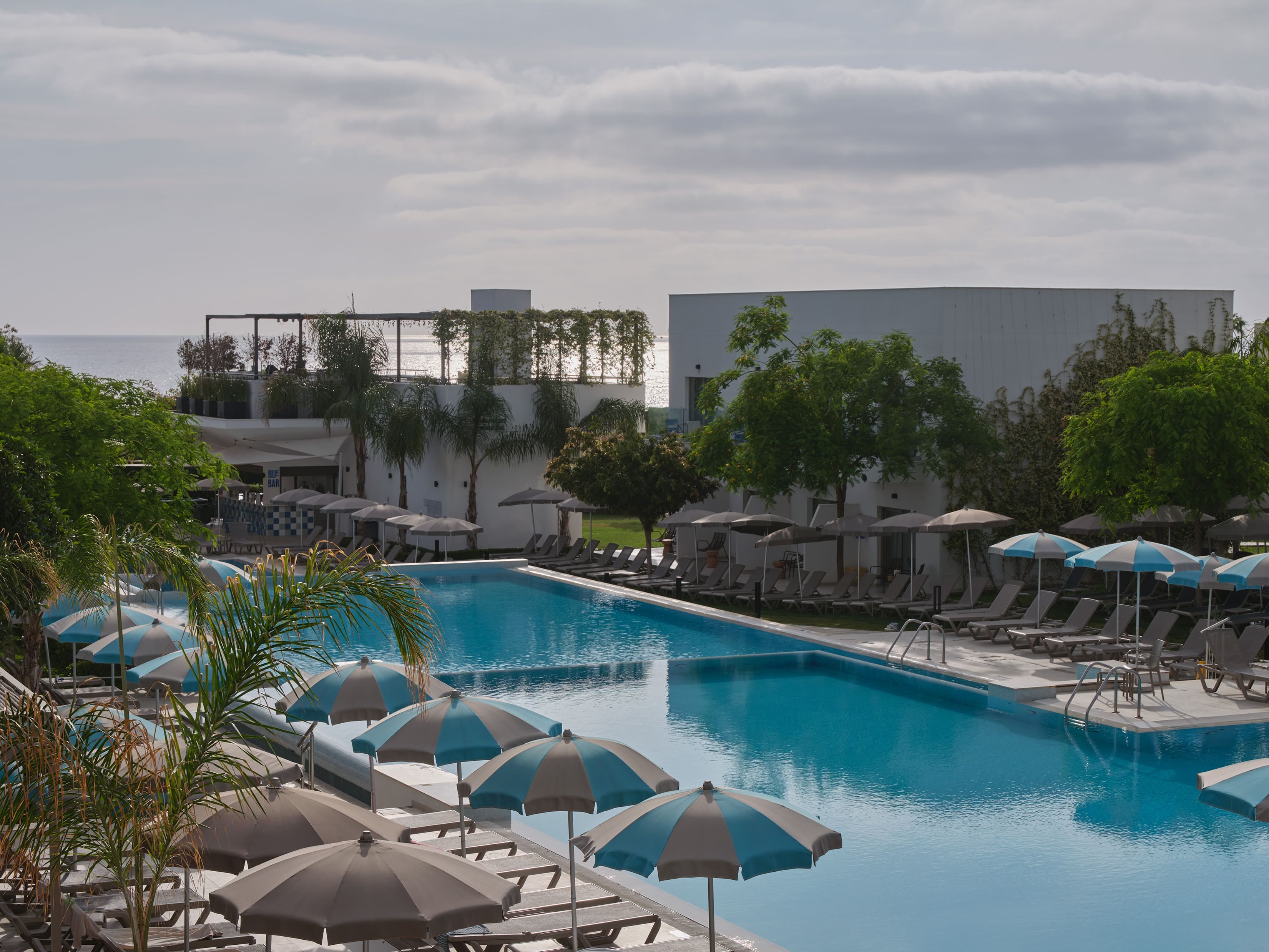 a pool with umbrellas and chairs by it