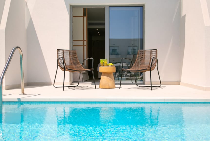 a chair and a table by a pool