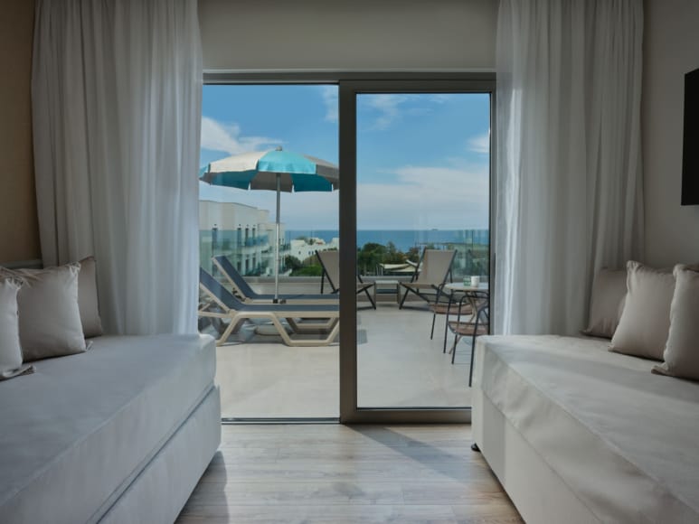 a room with a view of the ocean and a balcony