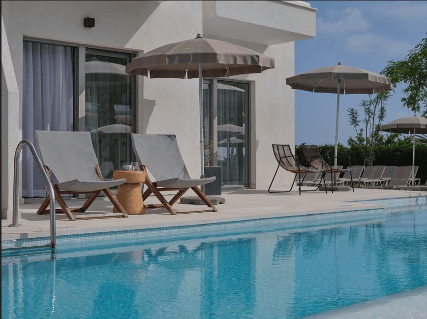 a pool with chairs and umbrellas