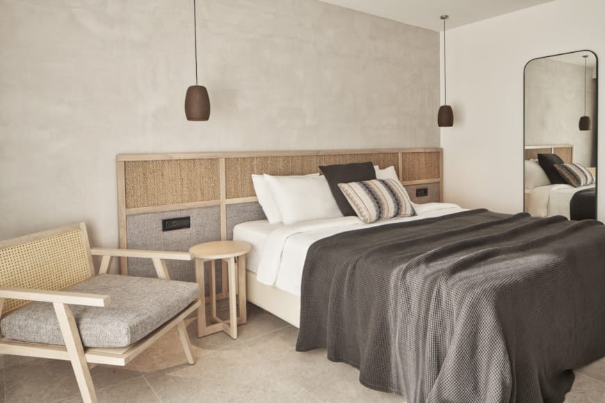 a room with a bed and a bench