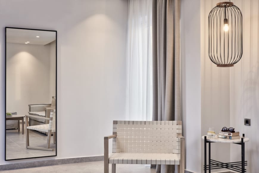 a room with a chair and a mirror