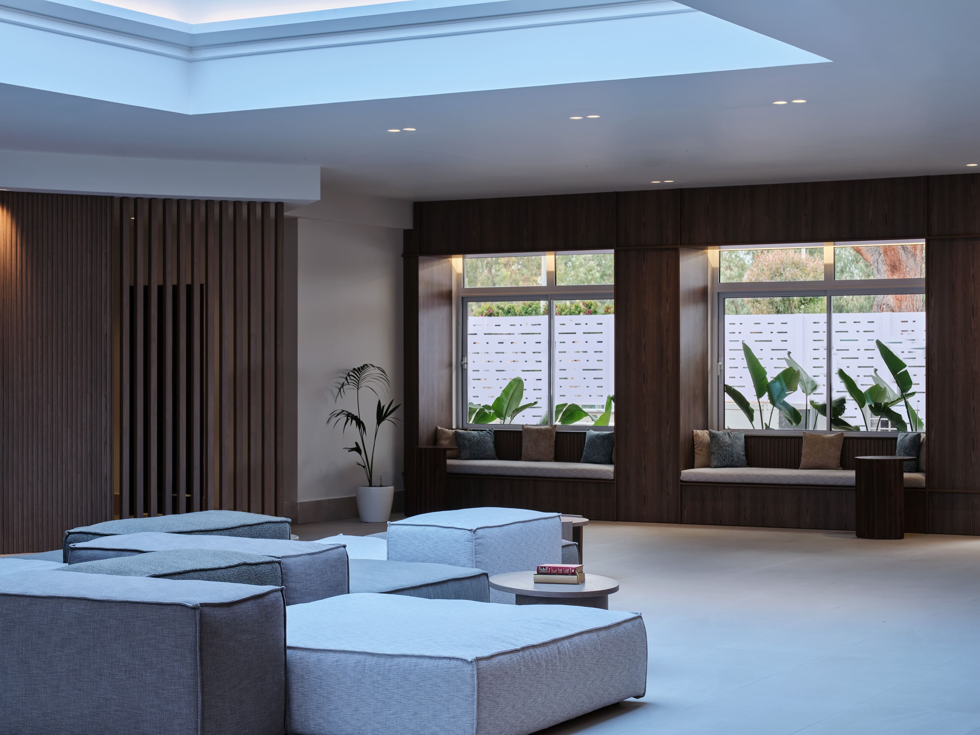 a room with a couch and a table with plants in it