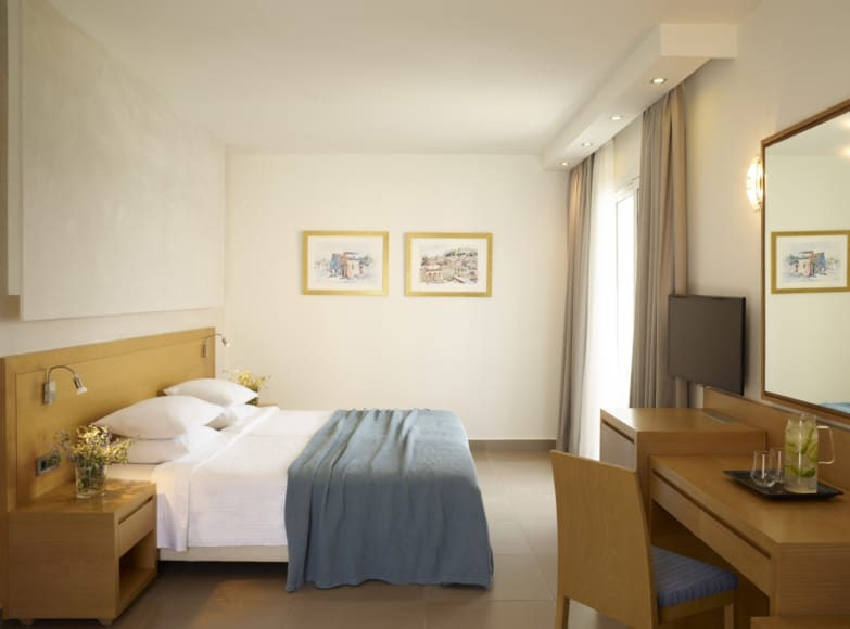 a hotel room with a bed and desk