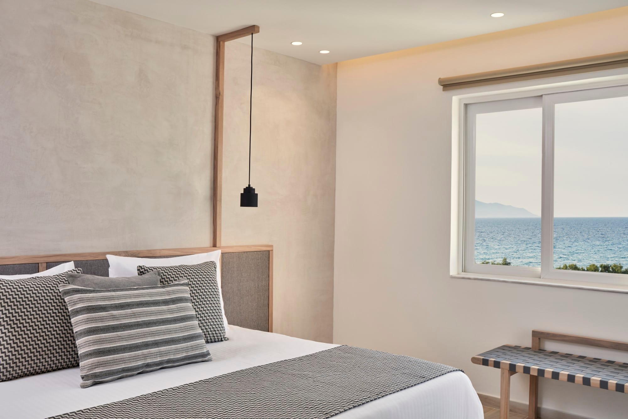 a bed with pillows and a lamp