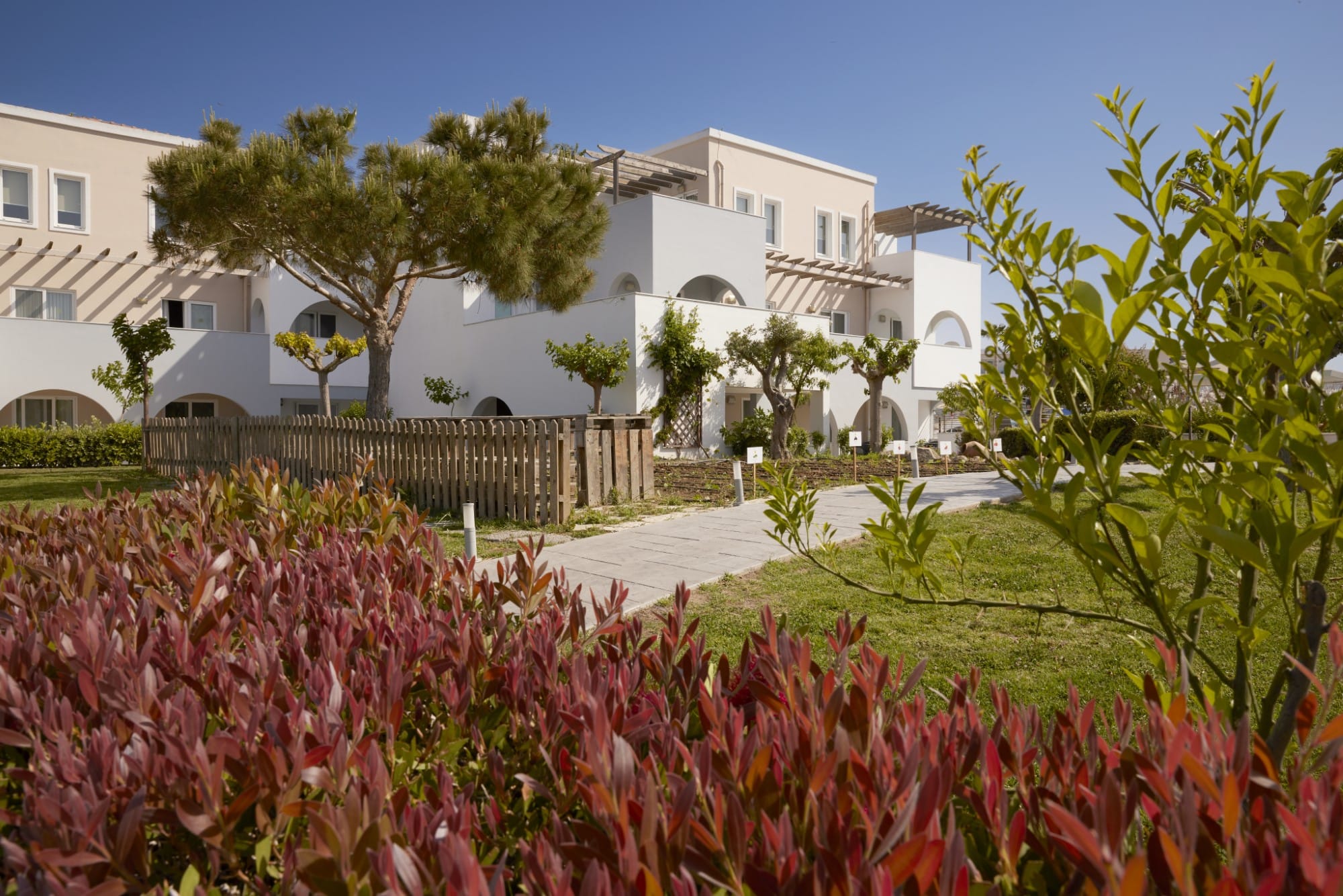 a building with a fence and trees