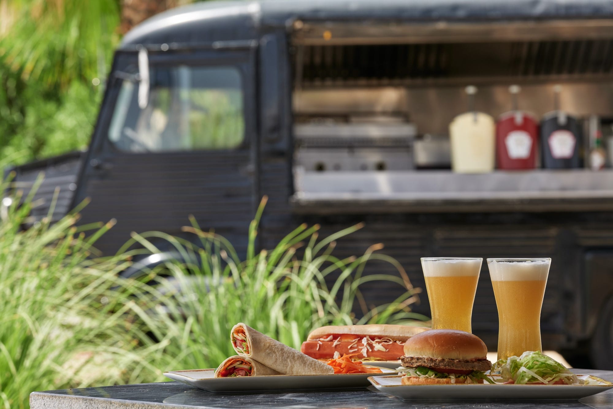 a tray of food next to a car