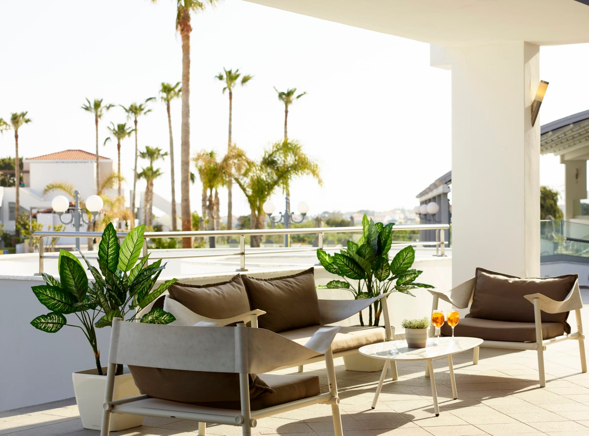 a patio with a couch and chairs