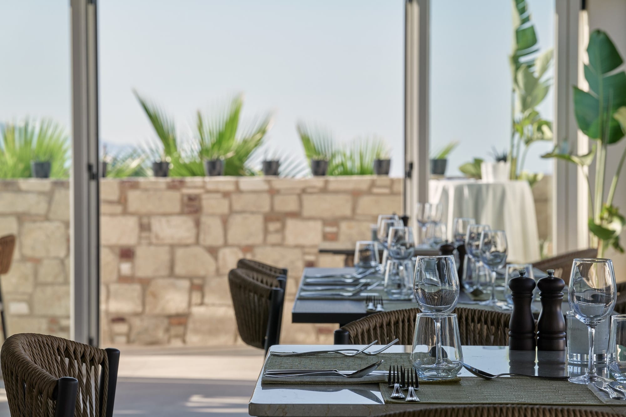 a set of tables with glasses on them